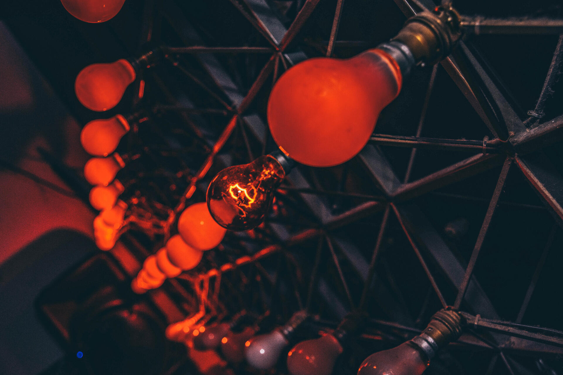 Red light bulbs on industrial metal frame